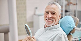 smiling man in dental chair 