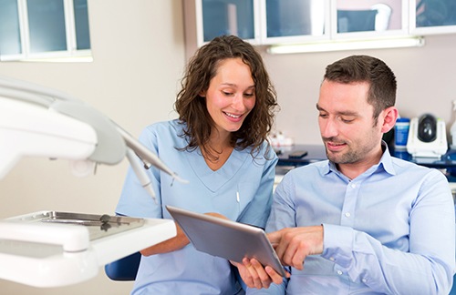Dentist in Roselle Park reviewing a personalized smile makeover plan with patient 