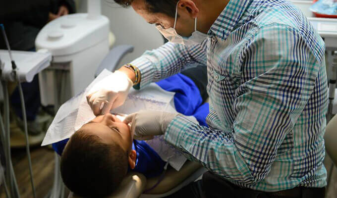 Dr. Gonzales working on child's smile