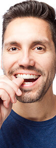man showing off top teeth